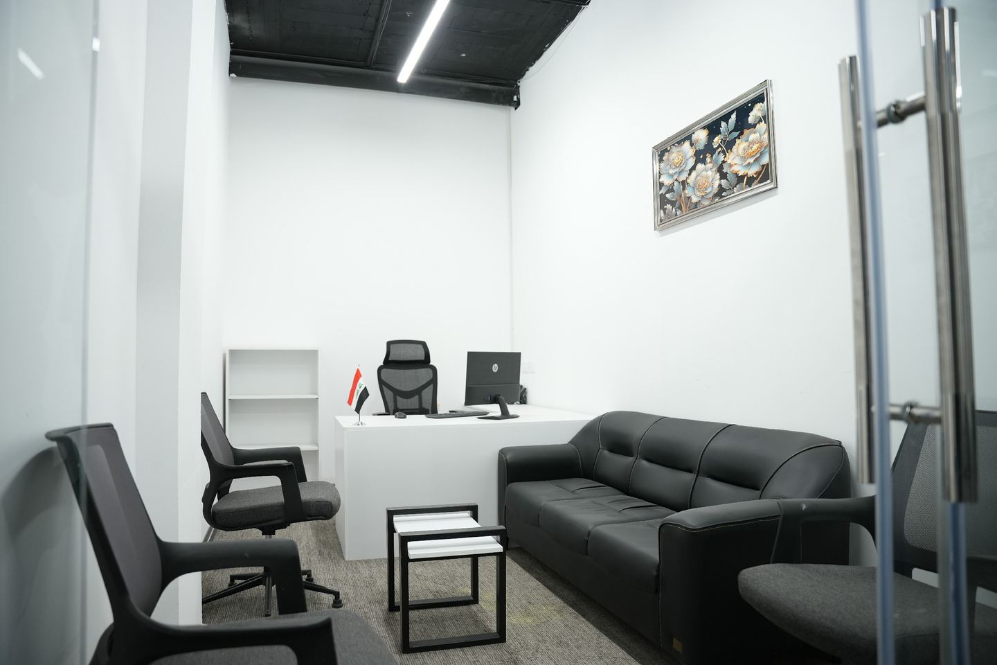 Executive private office with desk and leather sofa